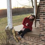 girl sitting on a porch with glass of wine in Yadkin Valley NC