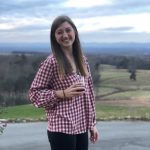 Girl with wine standing in front of mountain views