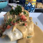 plate of cheese covered burrito