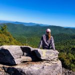 girl sitting on rock