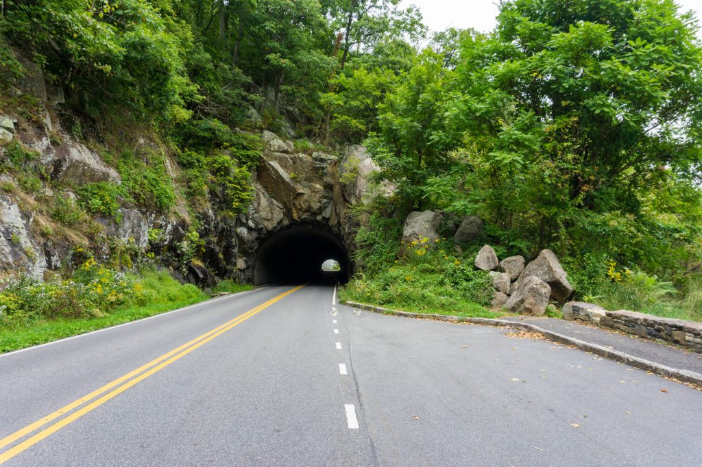 rock tunnel with road going through