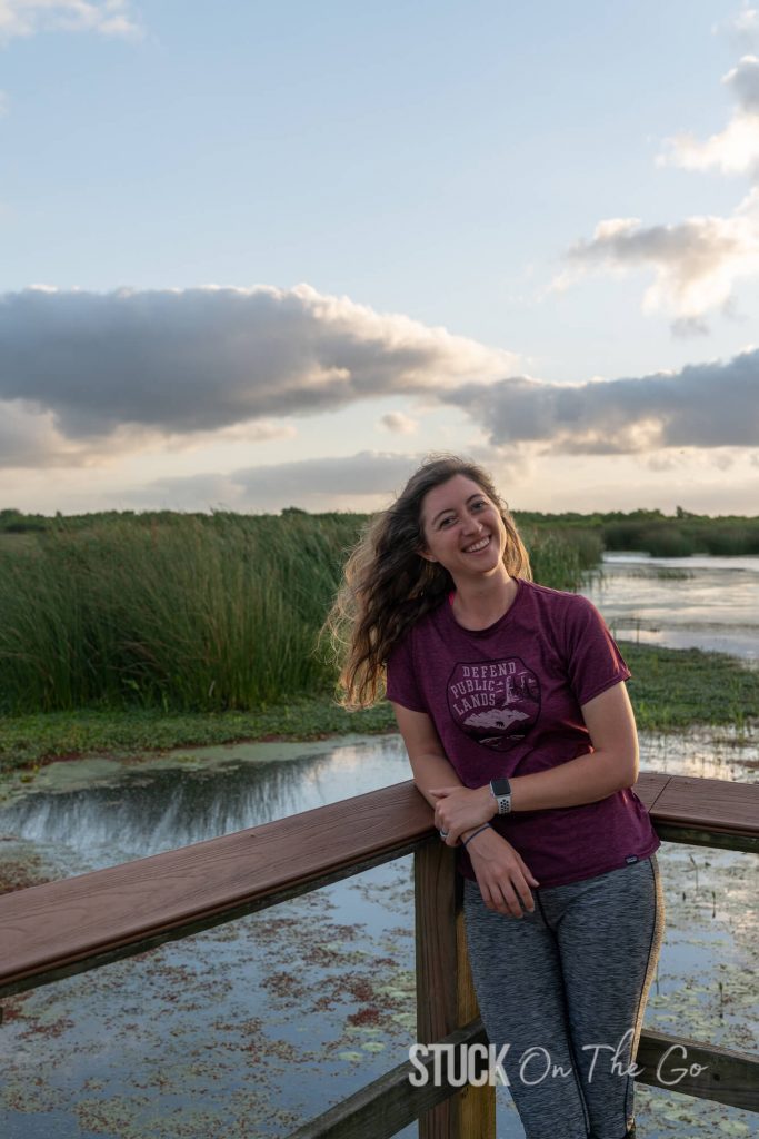 woman in front of railing at wetlands area