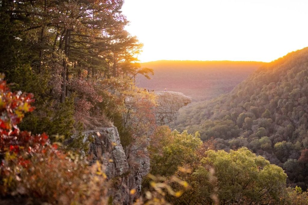 large rock cliff jutting out above a canyon