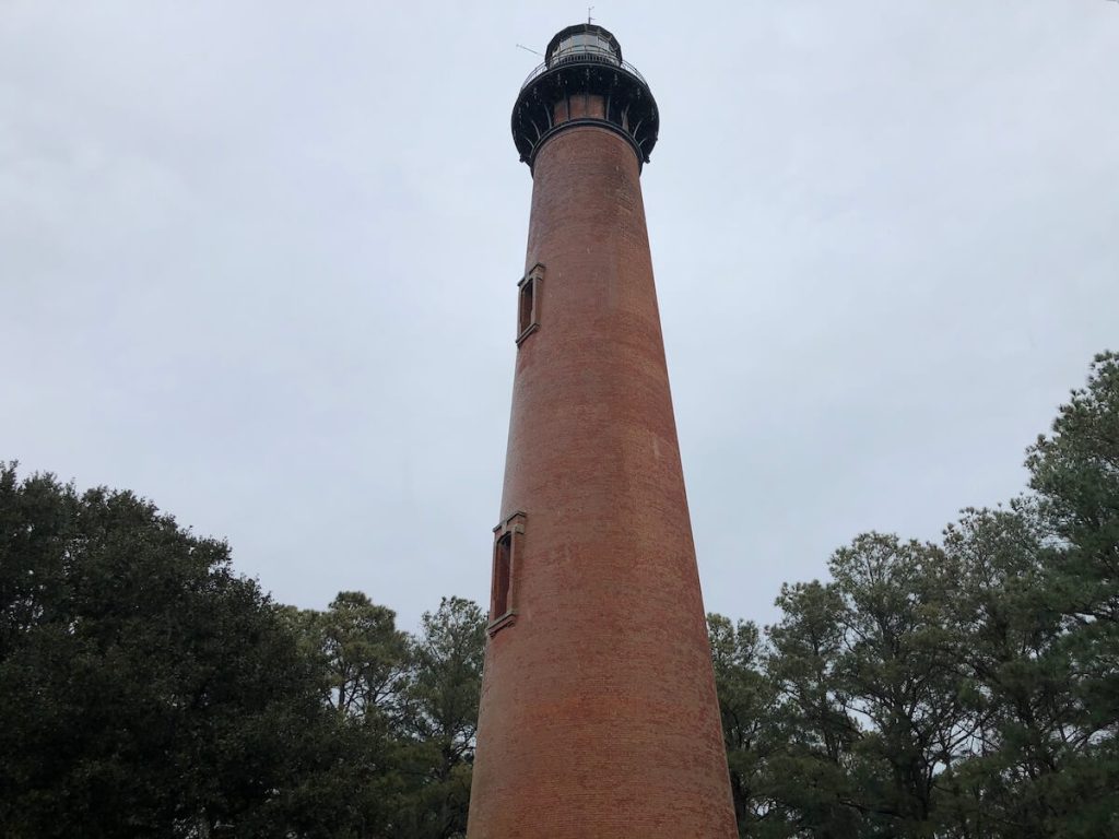 Currituck lighthouse on a cloudy day at one of the small beaches in North Carolina