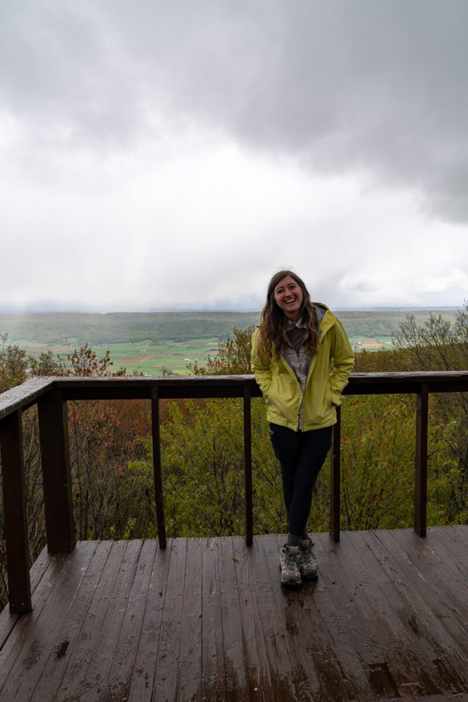 girl in front of railing on mountain