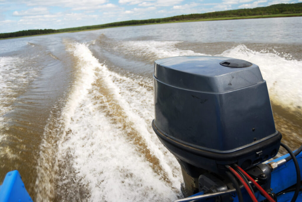 boat motor and wake behind it