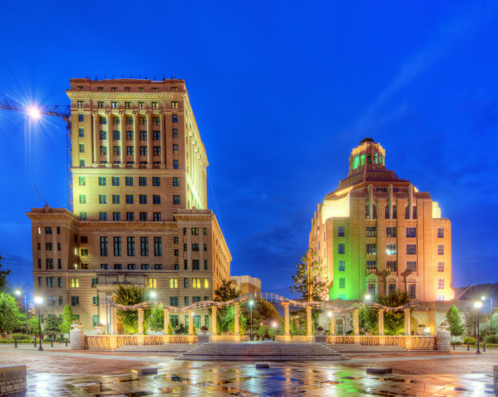 Two buildings in downtown Asheville at night.