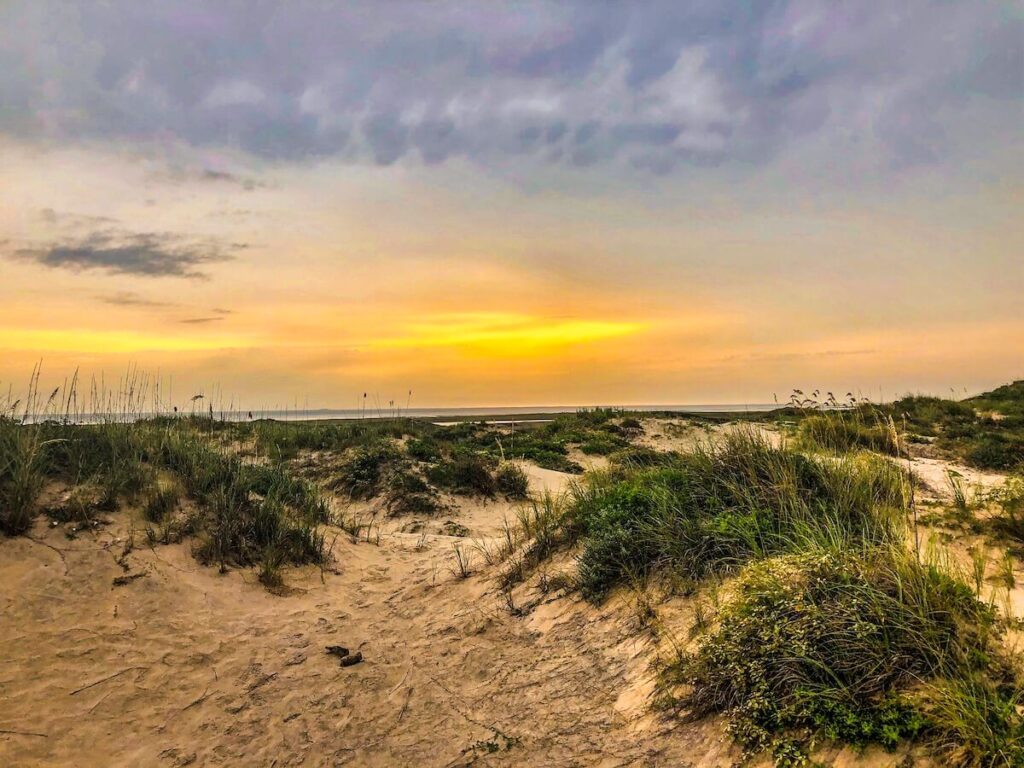 Sunset over dunes at the beach.