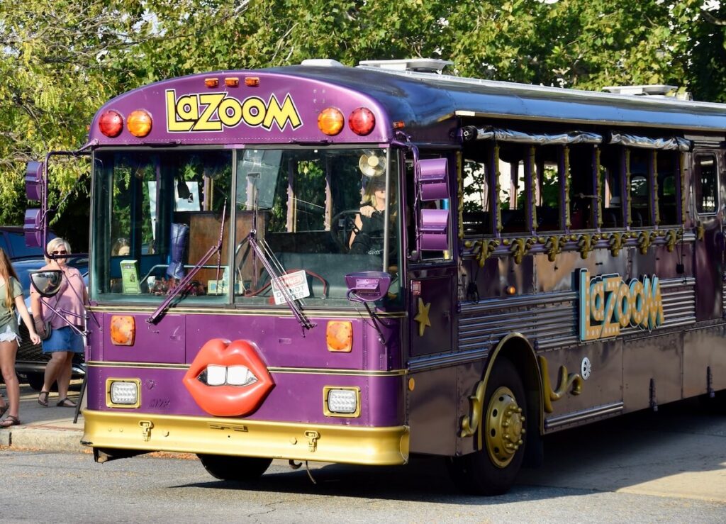 Purple LaZoom bus with fake lips on the front.