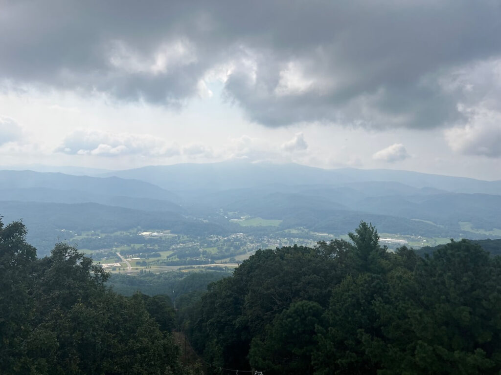 Hazy mountain view with a town below in the distance.