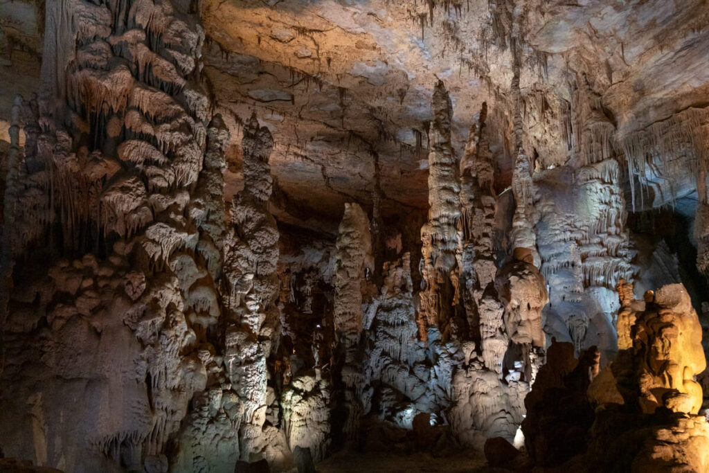 Large room of stalagmites in a cave.