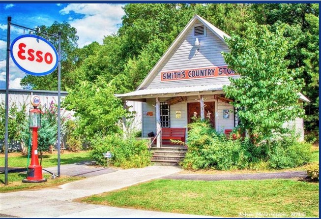 Exterior of restored Country Store building with old gas pump out front.