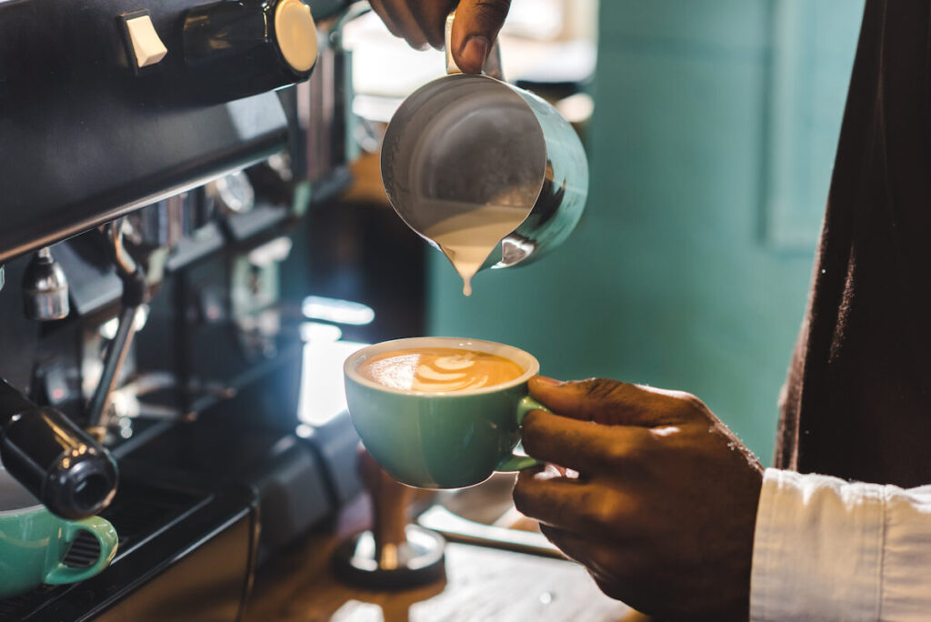 Barista pouring a capuccino.