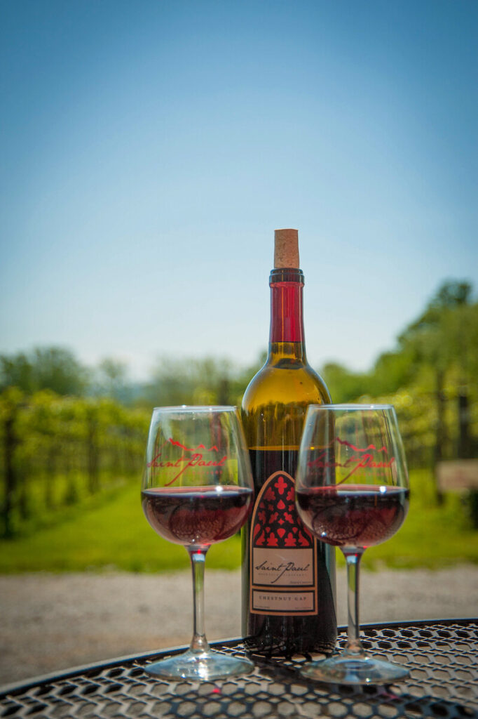 wine glass behind two glasses of wine at one of the wineries near Hendersonville, NC