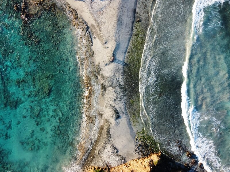 Aerial view of two different oceans meeting with small strip of sand in between
