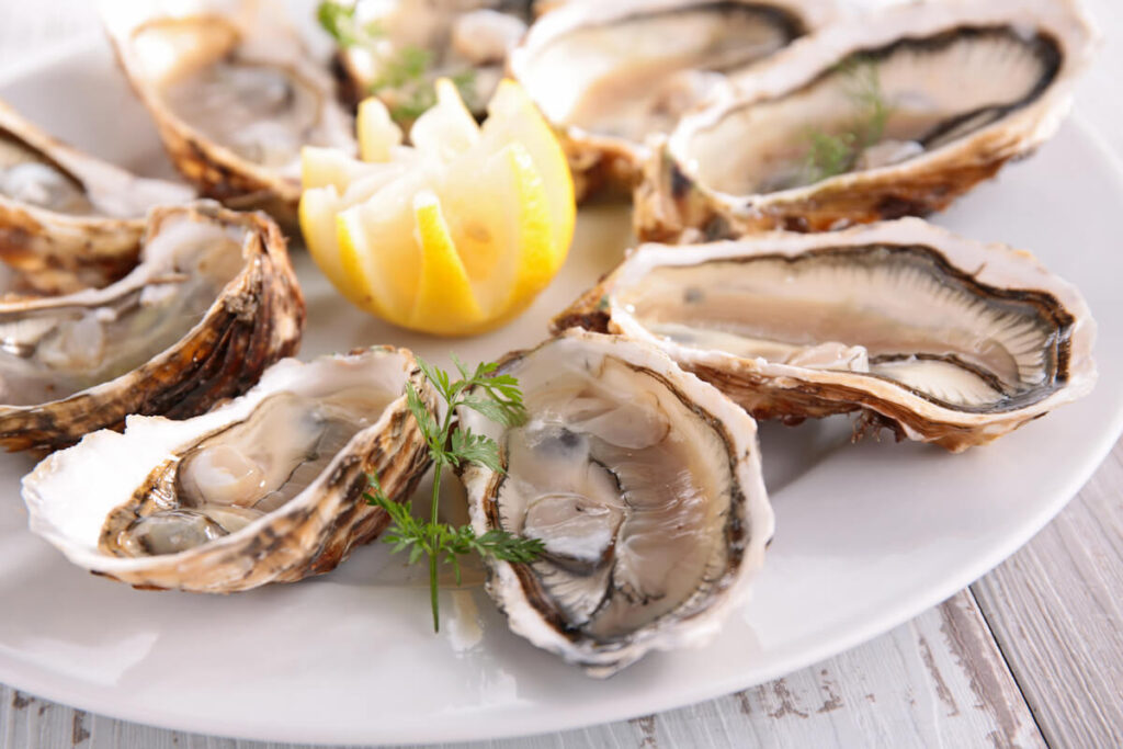 Shucked oysters on a plate with a lemon from one of the Red Hook, St. Thomas restaurants