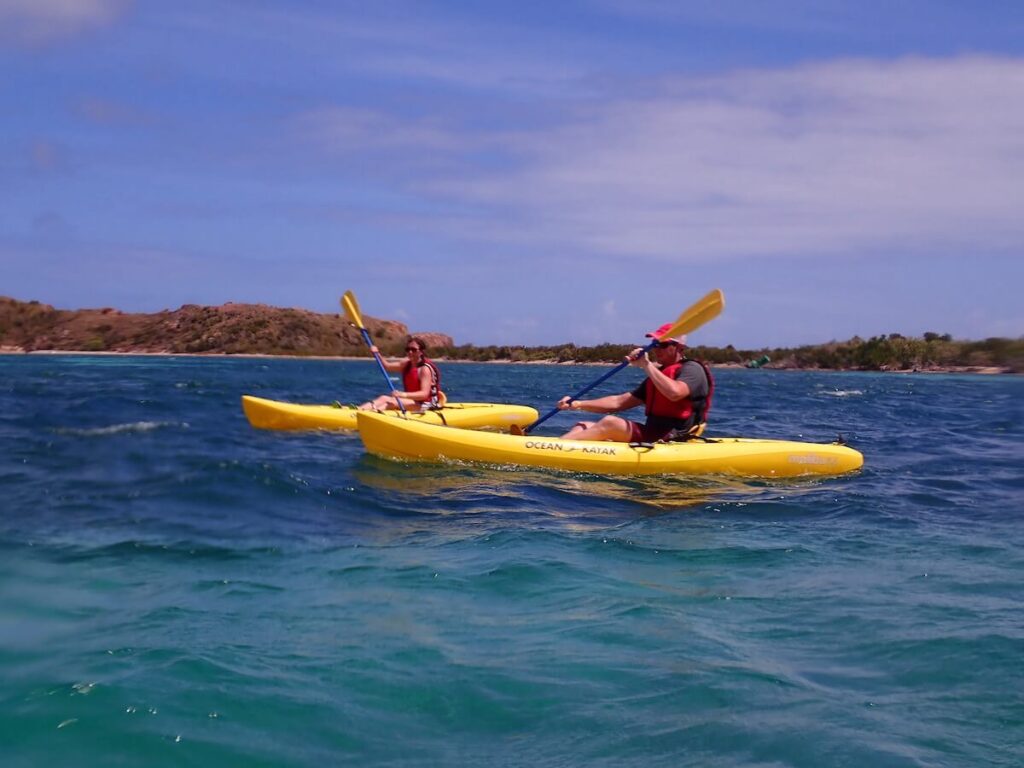 A couple kayaking through the ocean.