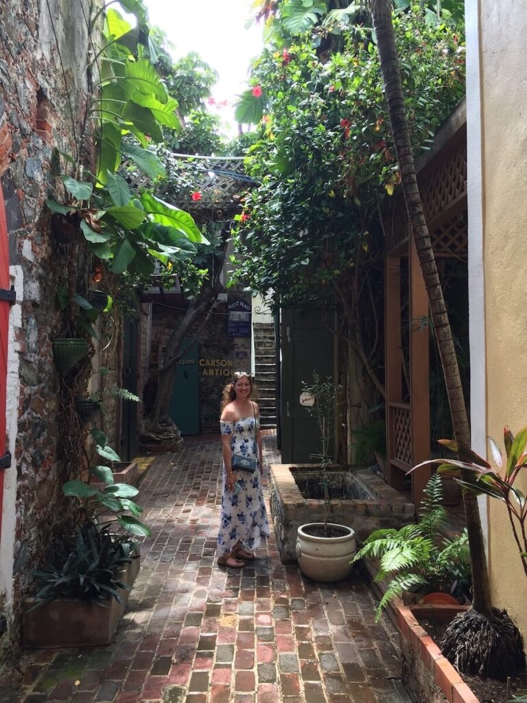 small brick alleyway with tropical plants growing on the sides that we saw on one of the St. Thomas food tours