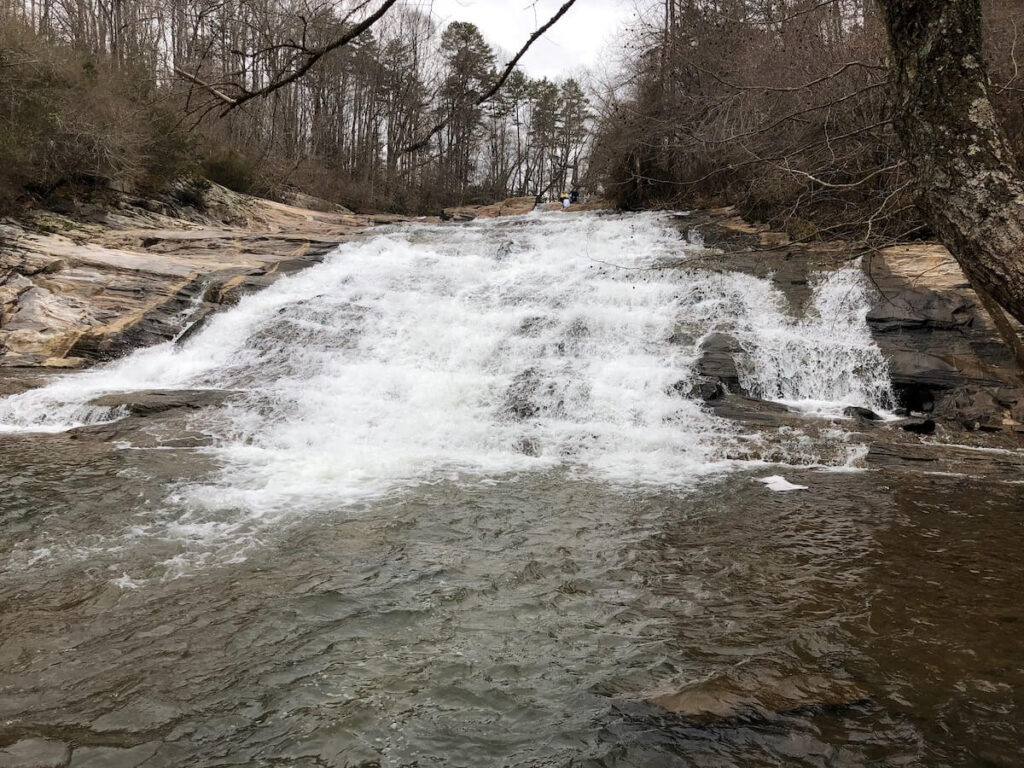 Short waterfalls that is wide and cascades down a rocky slope.