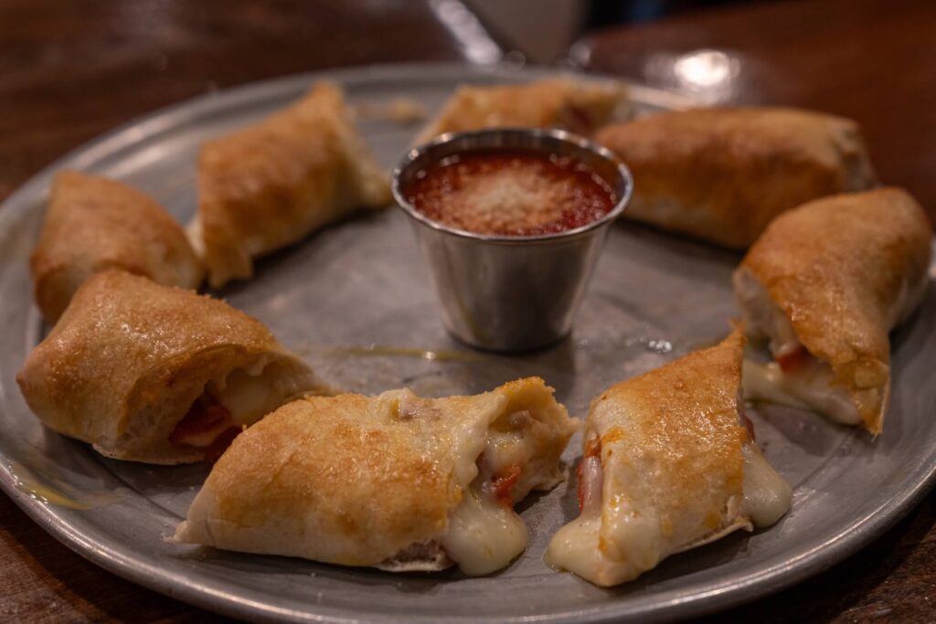 ring of pepperoni rolls around a cup of marinara