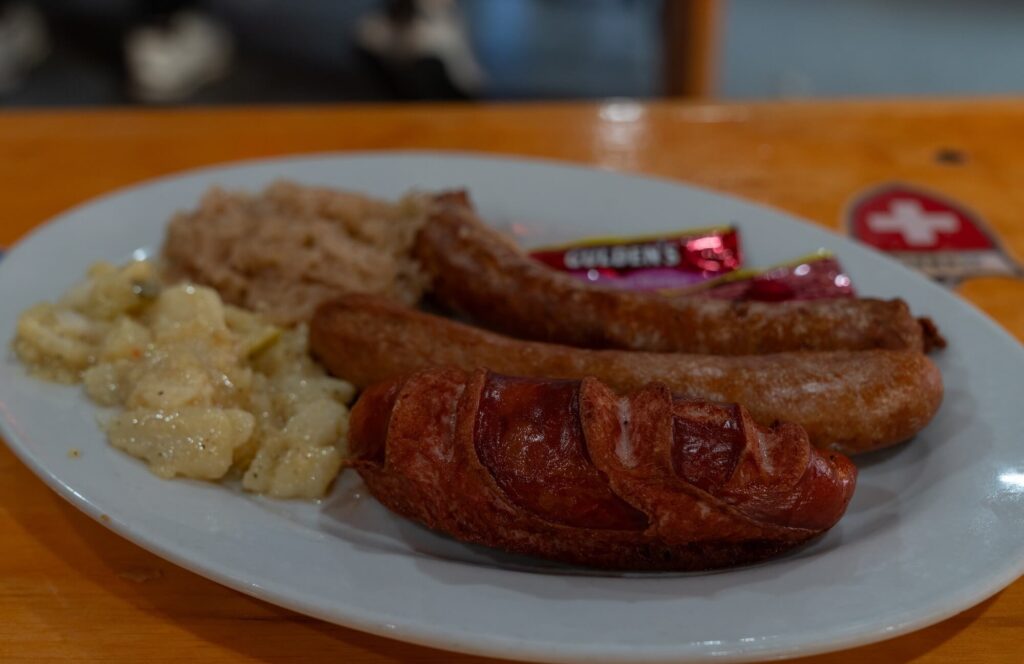 plate of sausage and potato salad
