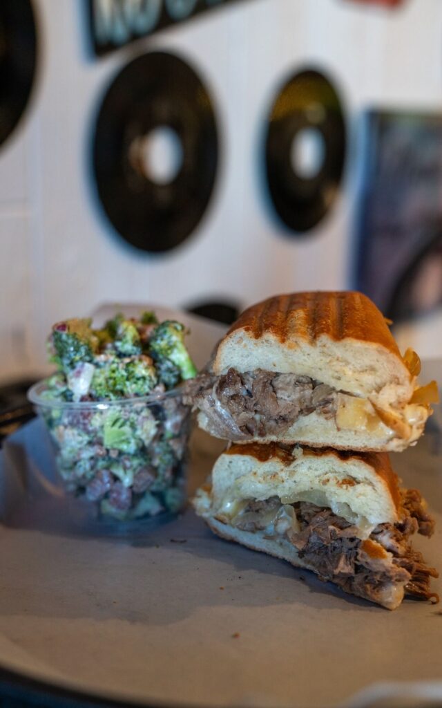 stacked steak & cheese sandwich with broccoli salad