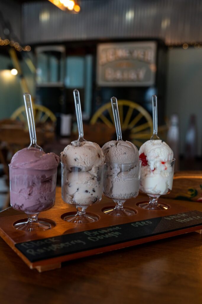 A flight of ice cream with a historic dairy cart in the background. Ice cream is integral to the culture of State College.